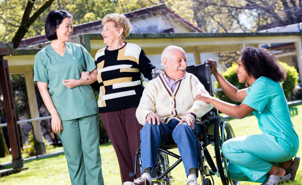 Two female physical therapist, occupational therapist assisting senior adults while in rehabilitation. Top 5 Benefits of Inpatient Rehabilitation.