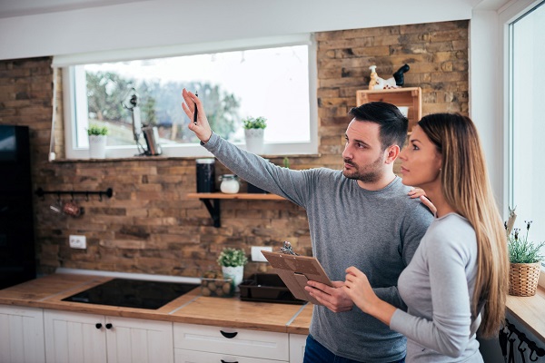 A caucasian couple young man and woman discussing home renovations.