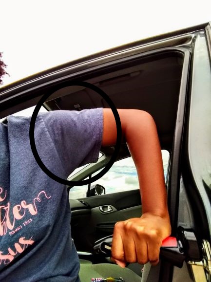 Arm of an African American woman using the Emson Portable Car Door Assist handle. Demonstrating the rotation it places on the shoulder joint.